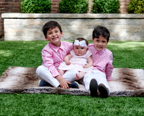 smiling siblings outside