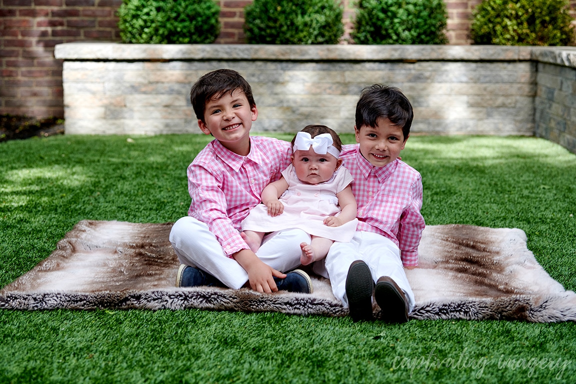 smiling siblings outside