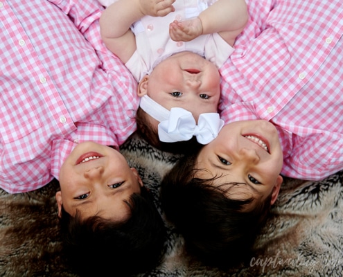 smiling siblings outside