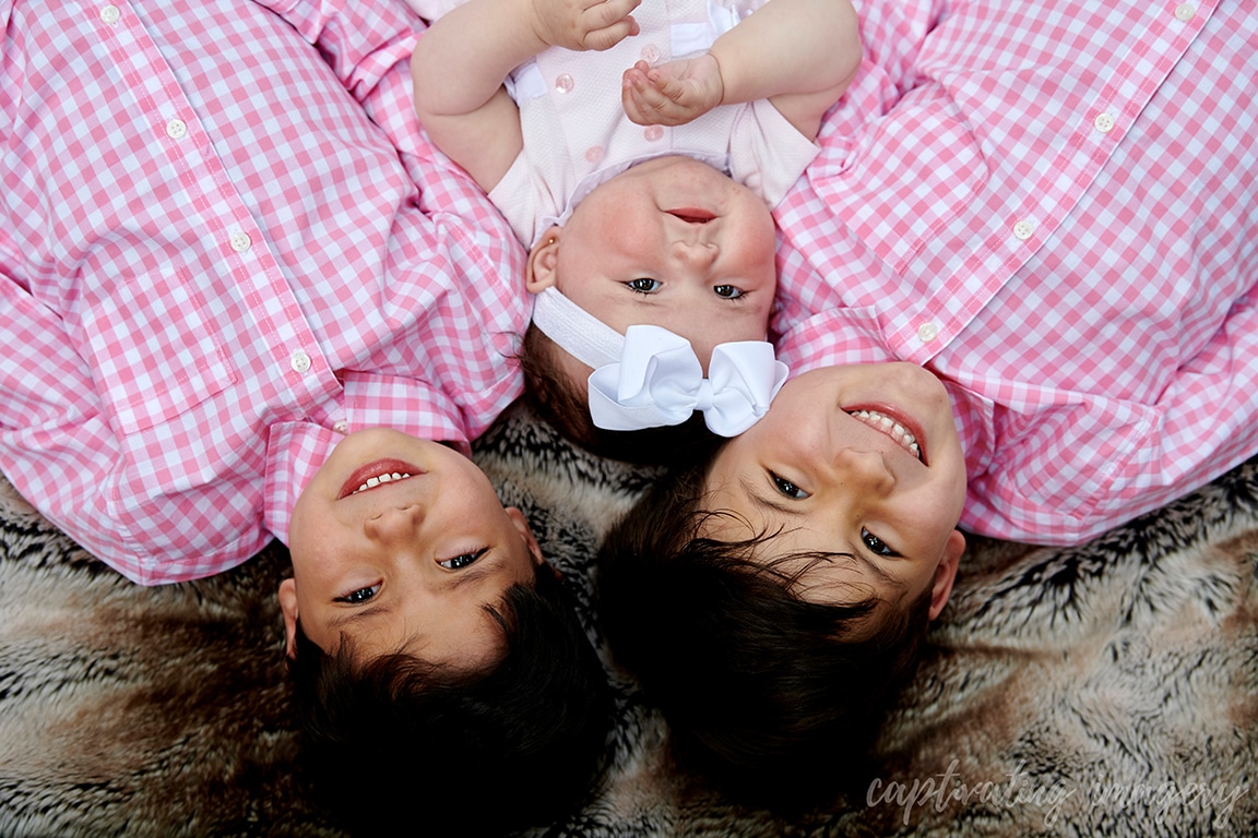 smiling siblings outside