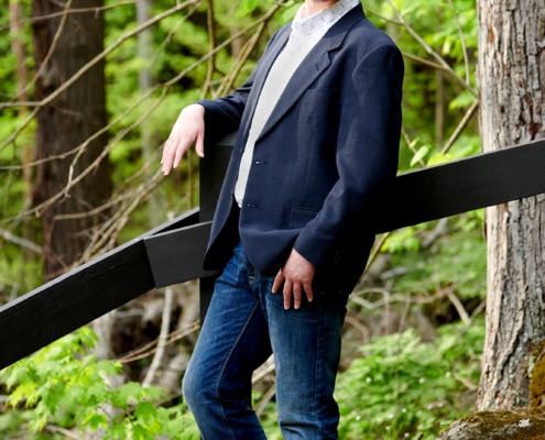 boy in suit jacket on hiking path