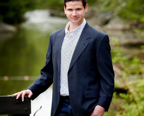 boy in suit jacket by river