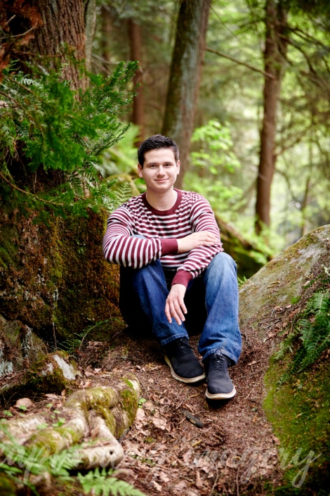 boy sitting in nature scene