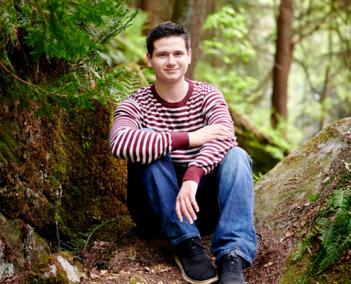 boy sitting in nature scene