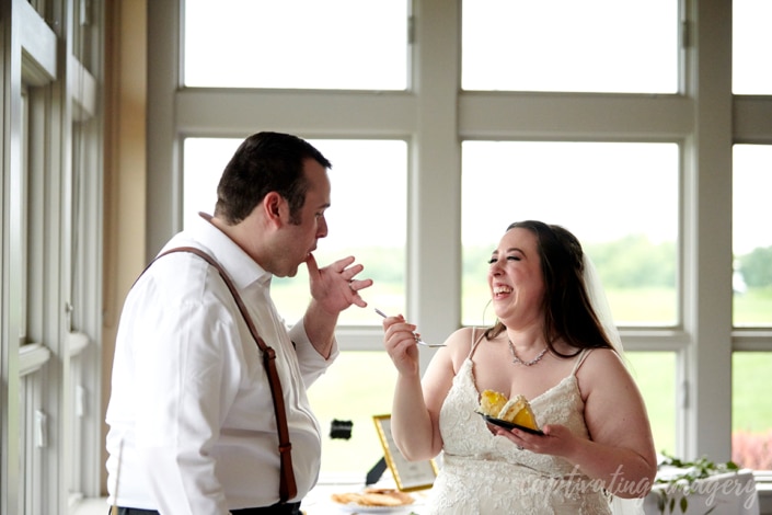 bride feeds groom wedding cake