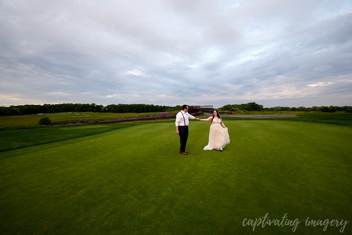 married couple on golf course under sky