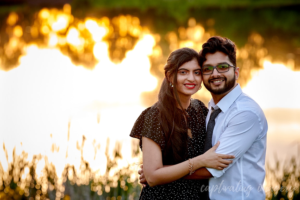 couple by pond at sunset