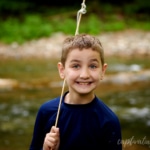 boy smiling with creek in background