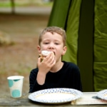 boy eats cinnamon roll