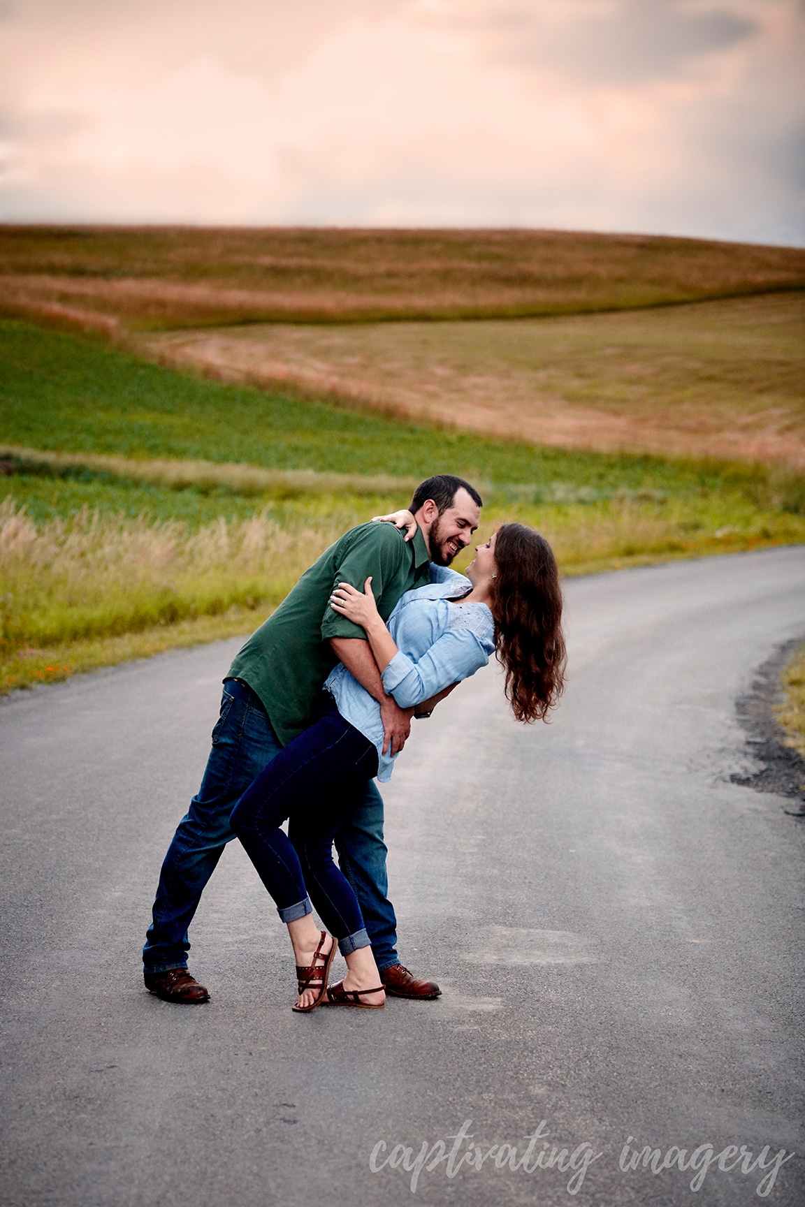 couple dances in front of sunset