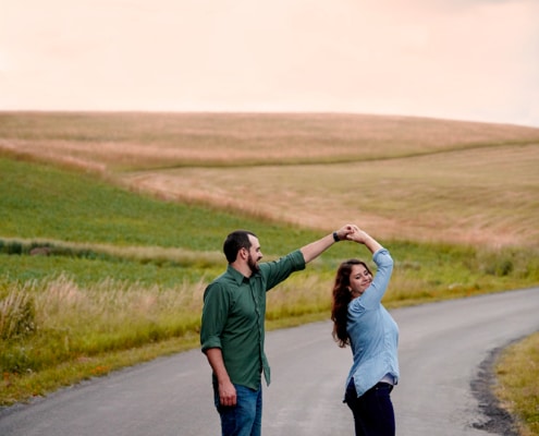 couple dances in front of sunset