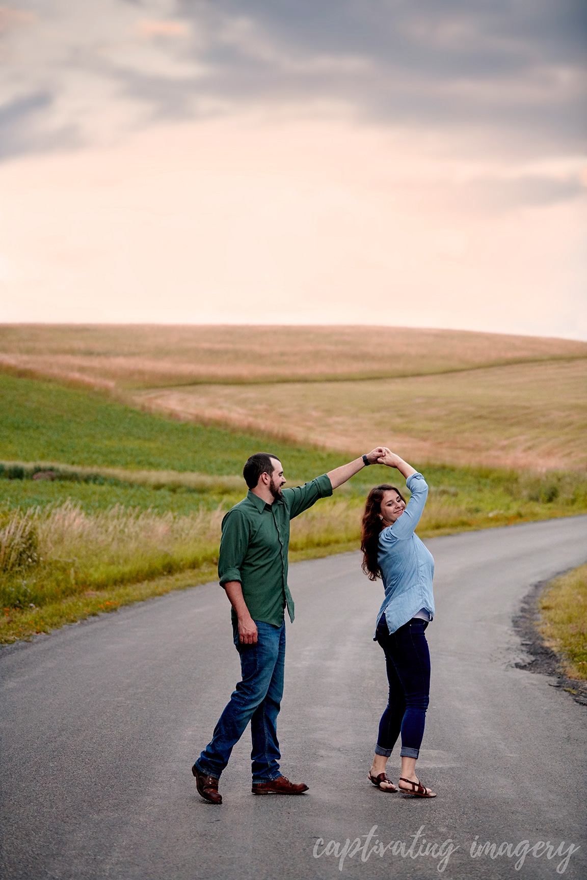 couple dances in front of sunset