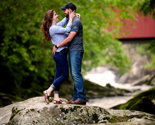 couple embraces on rocky terrain