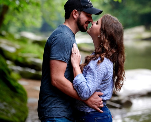 couple kissing by stream