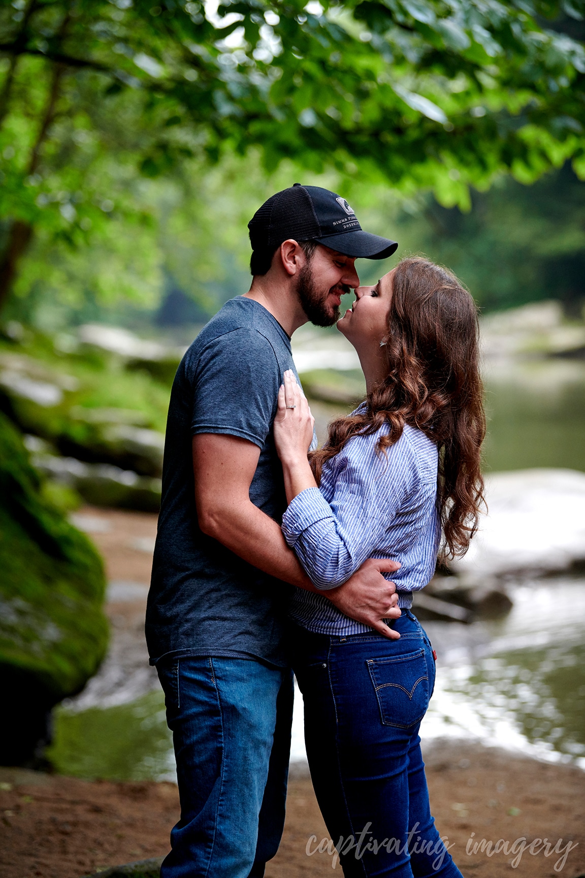 couple kissing by stream