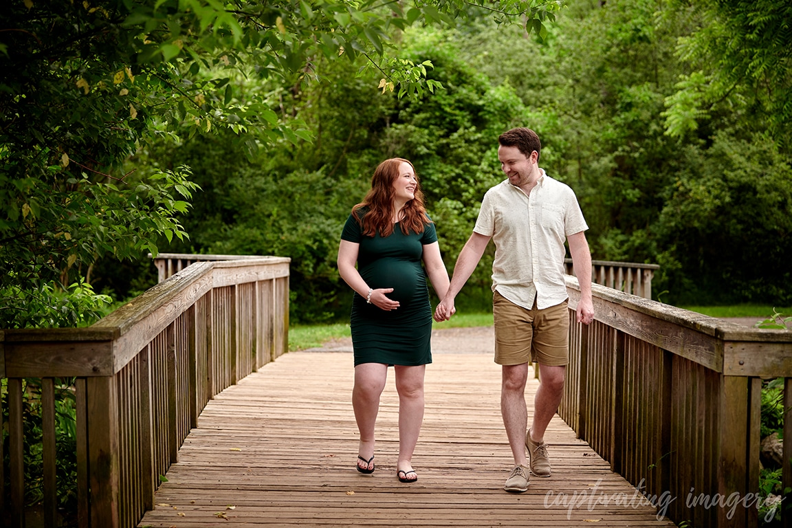 parents-to-be walking on bridge together