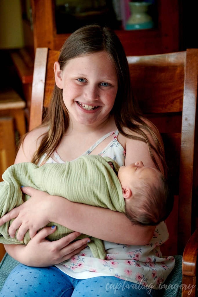 sister holding baby