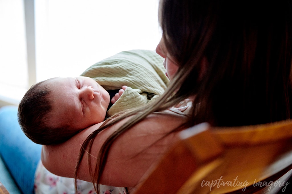 mom holding sleeping newborn